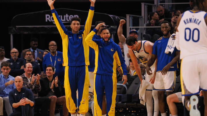 Dec 6, 2023; San Francisco, California, USA; The Golden State Warriors bench celebrates after a dunk by forward Jonathan Kuminga (00) during the fourth quarter at Chase Center. 