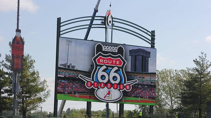 A crane raises the first half of the Route 66 shield into place on the scoreboard at Hammons Field — soon to be Route 66 Stadium — on April 23, 2026.