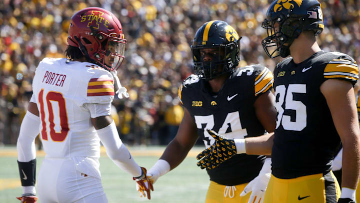 Iowa State’s Darien Porter (10) shakes hands with Iow’s Jay Higgins (34) and Luke Lachey (85) after the coin toss at the CyHawk game Saturday, Sept. 7, 2024 at Kinnick Stadium in Iowa City, Iowa.