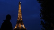 Jul 24, 2024; Paris, France; Tourists look at the Eiffel Tower before the Paris 2024 Olympic Summer Games. Mandatory Credit: Sarah Phipps-USA TODAY Sports