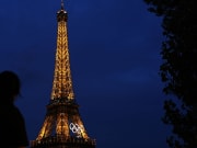 Jul 24, 2024; Paris, France; Tourists look at the Eiffel Tower before the Paris 2024 Olympic Summer Games. Mandatory Credit: Sarah Phipps-USA TODAY Sports