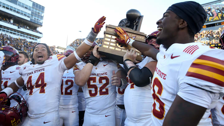 Iowa State players celebrate with the Cy-Hawk trophy after defeating Iowa Saturday, Sept. 7, 2024 at Kinnick Stadium in Iowa City, Iowa.