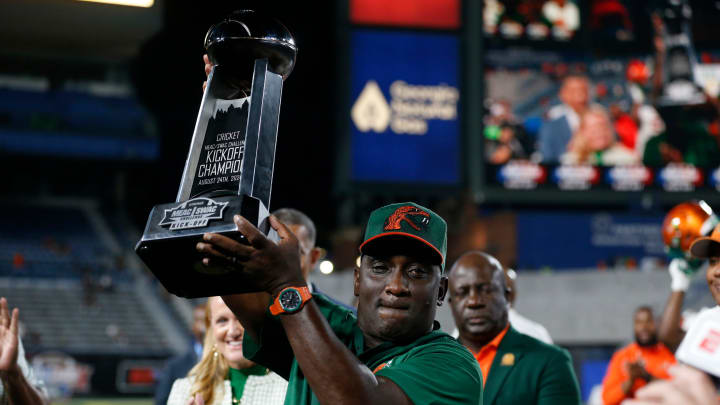 Florida A&M coach James Colzie III raises the game trophy after winning the Cricket MEAC-SWAC Challenge NCAA college football game against Norfolk State in Atlanta on Saturday, Aug. 24, 2024. Florida A&M won 24-23.