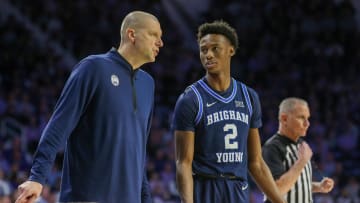 Feb 24, 2024; Manhattan, Kansas, USA; Brigham Young Cougars head coach Mark Pope talks to guard Jaxson Robinson (2) during a break in first-half action against the Kansas State Wildcats at Bramlage Coliseum. Mandatory Credit: Scott Sewell-USA TODAY Sports
