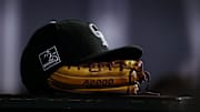 Sep 5, 2018; Denver, CO, USA; A detail view of a Colorado Rockies hat on top of a glove in the seventh inning against the San Francisco Giants at Coors Field. 