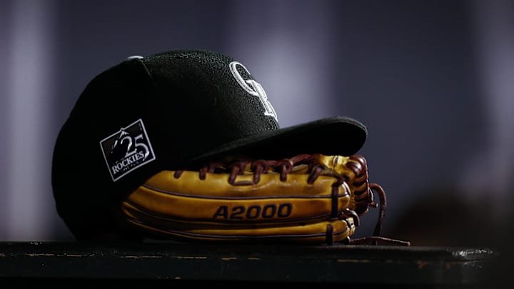 Sep 5, 2018; Denver, CO, USA; A detail view of a Colorado Rockies hat on top of a glove in the seventh inning against the San Francisco Giants at Coors Field. Sep 5, 2018; Denver, CO, USA; A detail view of a Colorado Rockies hat on top of a glove in the seventh inning against the San Francisco Giants at Coors Field.