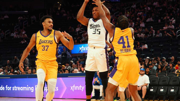 Jul 6, 2024; San Francisco, CA, USA; Sacramento Kings forward Yves Pons (35) controls the ball between Los Angeles Lakers forward Armel Traore (37) and guard Quincy Olivari (41) during the first quarter at Chase Center. Mandatory Credit: Kelley L Cox-USA TODAY Sports