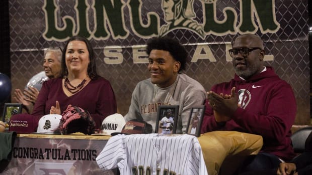 Lincoln baseball player Myles Bailey (center).