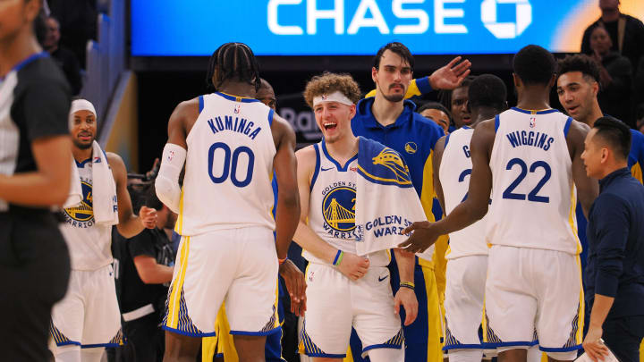 Dec 6, 2023; San Francisco, California, USA; Golden State Warriors guard Brandin Podziemski (2) celebrates with forward Jonathan Kuminga (00) after a time out is called against the Portland Trail Blazers during the fourth quarter at Chase Center. Mandatory Credit: Kelley L Cox-USA TODAY Sports