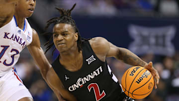 Cincinnati freshman guard Jizzle James (2) drives the ball against Kansas freshman guard Elmarko Jackson (13) in the first half of the Big 12 Conference Tournament first round game Wednesday, March 13, 2024, inside the T-Mobile Center in Kansas City, Mo.