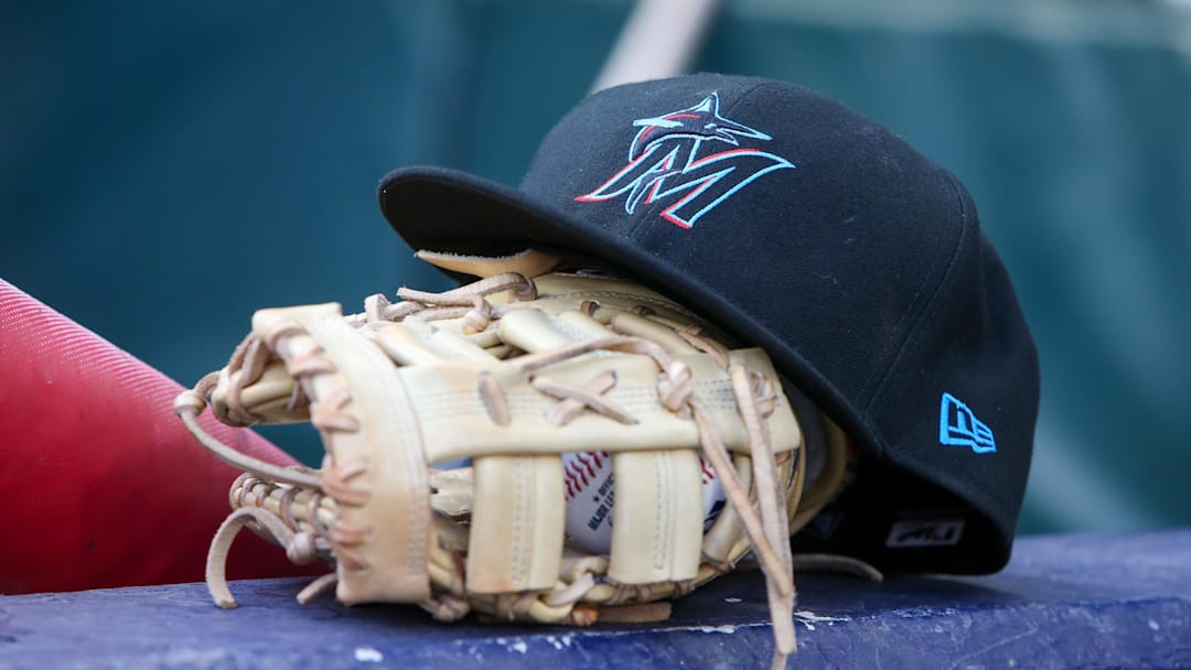 Miami Marlins hat and glove in the dugout