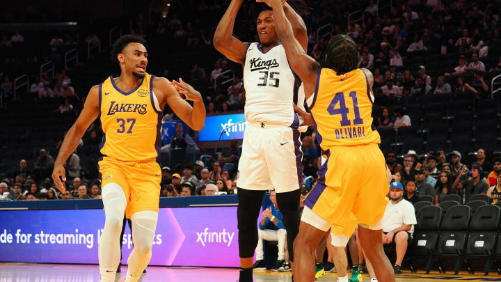 Jul 6, 2024; San Francisco, CA, USA; Sacramento Kings forward Yves Pons (35) controls the ball between Los Angeles Lakers forward Armel Traore (37) and guard Quincy Olivari (41) during the first quarter at Chase Center. Mandatory Credit: Kelley L Cox-USA TODAY Sports