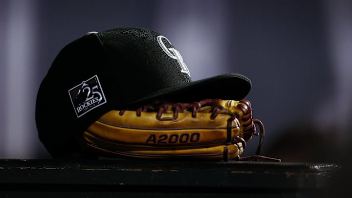 Sep 5, 2018; Denver, CO, USA; A detail view of a Colorado Rockies hat on top of a glove in the seventh inning against the San Francisco Giants at Coors Field. 