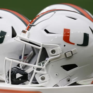 Miami Hurricanes helmets sit on the sidelines