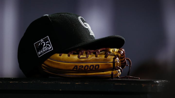 Sep 5, 2018; Denver, CO, USA; A detail view of a Colorado Rockies hat on top of a glove in the seventh inning against the San Francisco Giants at Coors Field. Sep 5, 2018; Denver, CO, USA; A detail view of a Colorado Rockies hat on top of a glove in the seventh inning against the San Francisco Giants at Coors Field.