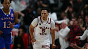 Feb 12, 2024; Lubbock, Texas, USA;  Texas Tech Red Raiders guard Darrion Williams (5) reacts after a shot against Kansas Jayhawks guard Elmarko Jackson (13) in the first half at United Supermarkets Arena. Mandatory Credit: Michael C. Johnson-Imagn Images
