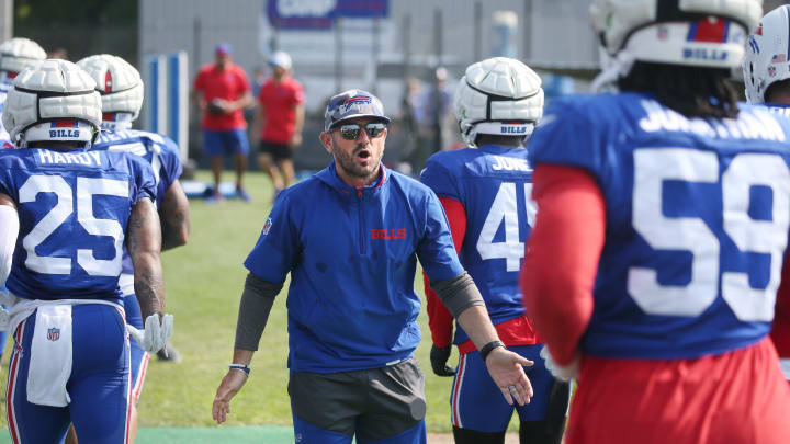 Bills defensive coordinator Bobby Babich pumps up the defensive squad as they head to the back field for drills.