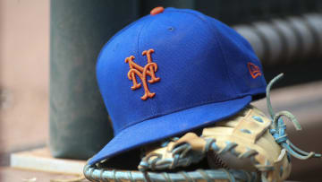 Jul 13, 2022; Atlanta, Georgia, USA; A detailed view of a New York Mets hat and glove in the dugout against the Atlanta Braves in the eighth inning at Truist Park. Mandatory Credit: Brett Davis-USA TODAY Sports