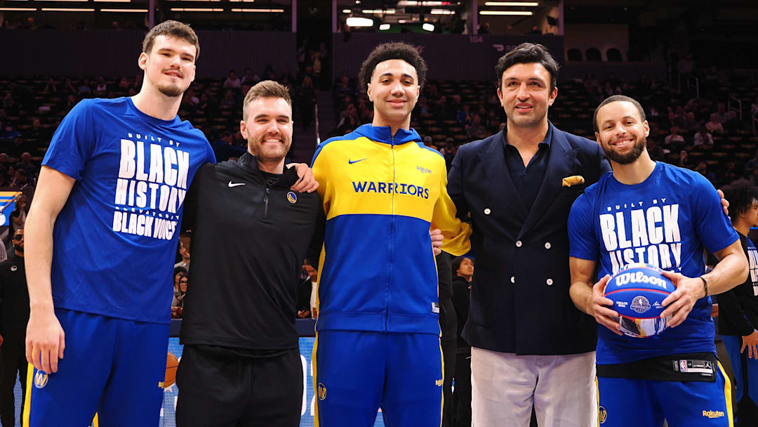 Golden State Warriors center Quinten Post (21), guard Pat Spencer (61), forward Trayce Jackson-Davis (32), former player Zaza Pachulia and guard Stephen Curry (30) are recognized for their participation in the All-star weekend before the game against the Orlando Magic at Chase Center. Mandatory Credit: Kelley L Cox-Imagn Images