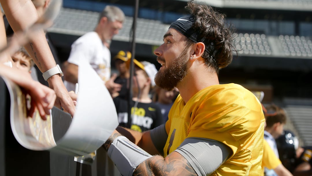 Iowa quarterback Brendan Sullivan (1) signs autographs for kids during Kids Day at Kinnick Saturday, Aug. 10, 2024 at Kinnick Stadium in Iowa City, Iowa.