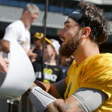 Iowa quarterback Brendan Sullivan (1) signs autographs for kids during Kids Day at Kinnick Saturday, Aug. 10, 2024 at Kinnick Stadium in Iowa City, Iowa.