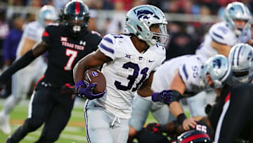 Oct 14, 2023; Lubbock, Texas, USA;  Kansas State Wildcats running back Dj Giddens (31) rushes against the Texas Tech Red Raiders in the first half at Jones AT&T Stadium and Cody Campbell Field. Mandatory Credit: Michael C. Johnson-Imagn Images