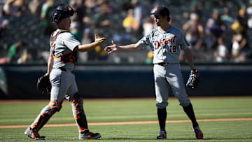 Sep 8, 2024; Oakland, California, USA; Detroit Tigers catcher Jake Rogers (34) and pitcher Kenta Maeda (18) celebrate their 9-1 victory over the Oakland Athletics at Oakland-Alameda County Coliseum. 