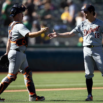 Sep 8, 2024; Oakland, California, USA; Detroit Tigers catcher Jake Rogers (34) and pitcher Kenta Maeda (18) celebrate their 9-1 victory over the Oakland Athletics at Oakland-Alameda County Coliseum. 