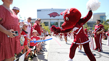 Sep 9, 2023; Fayetteville, Arkansas, USA;  Arkansas Razorbacks mascot entertains fans during the  Hog Walk  prior to the game against the Kent State Golden Flashes at Donald W. Reynolds Razorback Stadium. Mandatory Credit: Nelson Chenault-Imagn Images