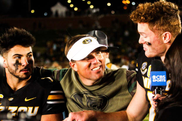 Missouri Tigers running back Cody Schrader, coach Eli Drinkwitz and quarterback Brady Cook talk after a game at Faurot Field.