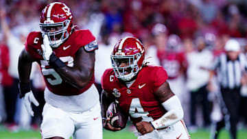 Sep 28, 2024; Tuscaloosa, Alabama, USA; Alabama Crimson Tide quarterback Jalen Milroe (4) runs for a touchdown during the first quarter against the Georgia Bulldogs at Bryant-Denny Stadium. Mandatory Credit: John David Mercer-Imagn Images