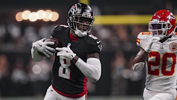 Sep 22, 2024; Atlanta, Georgia, USA; Atlanta Falcons tight end Kyle Pitts (8) runs against Kansas City Chiefs safety Justin Reid (20) after a catch during the first half at Mercedes-Benz Stadium.