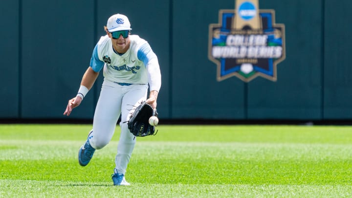 Jun 18, 2024; Omaha, NE, USA; North Carolina Tar Heels center fielder Vance Honeycutt (7) reaches for the ball during the fifth inning against the Florida State Seminoles at Charles Schwab Field Omaha. 