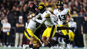 Sep 19, 2025; Piscataway, New Jersey, USA; Rutgers Scarlet Knights running back Antwan Raymond (3) is tackled by Iowa Hawkeyes defensive back Koen Entringer (4) and defensive back Xavier Nwankpa (1) during the first half at SHI Stadium. Mandatory Credit: Vincent Carchietta-Imagn Images