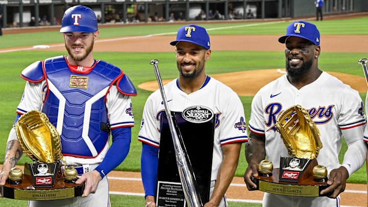 Apr 10, 2024; Arlington, Texas, USA; (from left) Texas Rangers first baseman Nathaniel Lowe (30) and catcher Jonah Heim (28) and second baseman Marcus Semien (2) and right fielder Adolis Garcia (53) and shortstop Corey Seager (5) pose with their Gold Glove and Silver Slugger awards before the game between the Texas Rangers and the Oakland Athletics at Globe Life Field. Mandatory Credit: Jerome Miron-Imagn Images