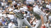 Sep 28, 2025; San Diego, California, USA; Arizona Diamondbacks third baseman Jordan Lawlar (10) throws over Brandon Pfaadt (32) as he tries to get the out on San Diego Padres right fielder Fernando Tatis Jr. (23) during the first inning at Petco Park. Mandatory Credit: Denis Poroy-Imagn Images