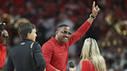 Feb 17, 2024; Houston, Texas, USA; Houston Cougars former quarterback and Heisman Trophy winner Andre Ware waves to fans before the game against the Texas Longhorns at Fertitta Center. Mandatory Credit: Troy Taormina-Imagn Images
