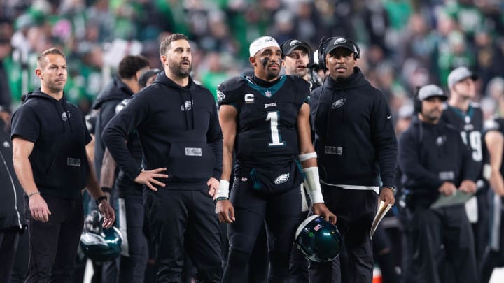 Dec 25, 2023; Philadelphia, Pennsylvania, USA; Philadelphia Eagles head coach Nick Sirianni (L) and quarterback Jalen Hurts (1) and offensive coordinator Brian Johnson (R) look on during the second quarter against the New York Giants at Lincoln Financial Field. Mandatory Credit: Bill Streicher-USA TODAY Sports