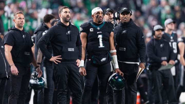 Dec 25, 2023; Philadelphia, Pennsylvania, USA; Philadelphia Eagles head coach Nick Sirianni (L) and quarterback Jalen Hurts (1) and offensive coordinator Brian Johnson (R) look on during the second quarter against the New York Giants at Lincoln Financial Field. Mandatory Credit: Bill Streicher-USA TODAY Sports