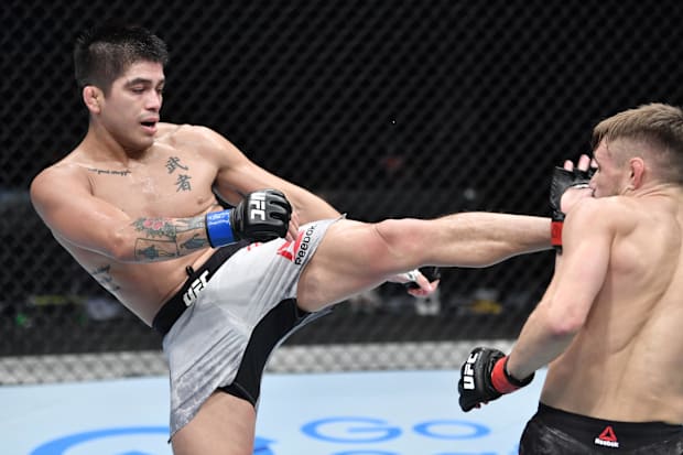 John Castañeda kicks Nathaniel Wood in their bantamweight fight during a UFC Fight Night.