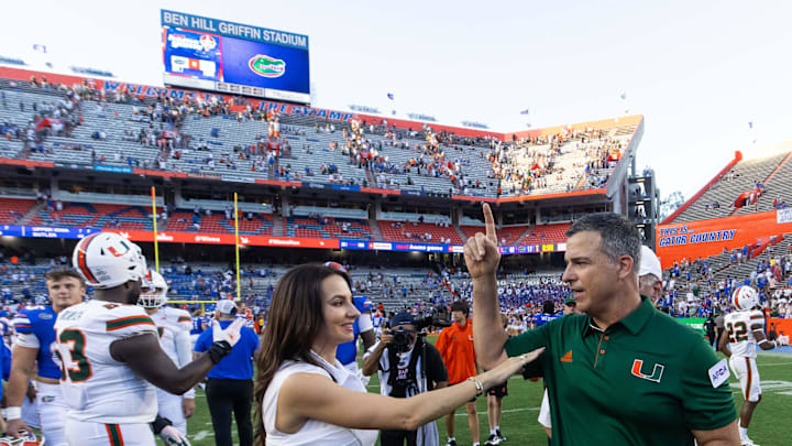 Jessica Cristobal congratulates her husband Miami Hurricanes head coach Mario Cristobal after defeating the Gators during the season opener at Ben Hill Griffin Stadium in Gainesville, FL on Saturday, August 31, 2024 against the University of Miami Hurricanes. The Hurricanes defeated the Gators 41-17. [Doug Engle/Gainesville Sun]