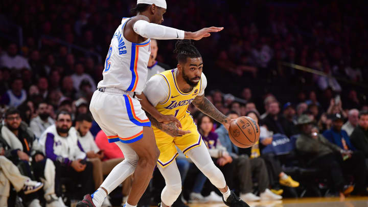 Mar 4, 2024; Los Angeles, California, USA; Los Angeles Lakers guard D'Angelo Russell (1) moves the ball against Oklahoma City Thunder guard Shai Gilgeous-Alexander (2) during the first half at Crypto.com Arena. Mandatory Credit: Gary A. Vasquez-USA TODAY Sports