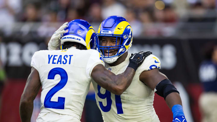 Nov 26, 2023; Glendale, Arizona, USA; Los Angeles Rams defensive tackle Kobie Turner (91) celebrates a play with safety Russ Yeast (2) against the Arizona Cardinals at State Farm Stadium. Mandatory Credit: Mark J. Rebilas-USA TODAY Sports