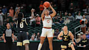 Jan 11, 2025; Coral Gables, Florida, USA; Miami Hurricanes guard Matthew Cleveland (0) shoots the basketball over Wake Forest Demon Deacons guard Ty-Laur Johnson (8) during the first half at Watsco Center. Mandatory Credit: Sam Navarro-Imagn Images