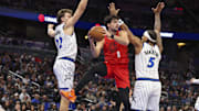 Nov 10, 2025; Orlando, Florida, USA; Portland Trail Blazers forward Deni Avdija (8) passes the ball past Orlando Magic forward Franz Wagner (22) and forward Paolo Banchero (5) in the first quarter  at Kia Center. Mandatory Credit: Nathan Ray Seebeck-Imagn Images