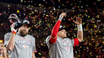 Jan 26, 2025; Kansas City, MO, USA; Confetti falls as Kansas City Chiefs tight end Travis Kelce (left) celebrates with the Lamar Hunt Trophy with quarterback Patrick Mahomes after defeating the Buffalo Bills during the AFC Championship game at GEHA Field at Arrowhead Stadium. Mandatory Credit: Mark J. Rebilas-Imagn Images