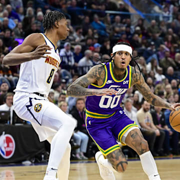 Jan 10, 2024; Salt Lake City, Utah, USA; Utah Jazz guard Jordan Clarkson (00) dribbles around Denver Nuggets guard Peyton Watson (8) during the second half at the Delta Center. Mandatory Credit: Christopher Creveling-Imagn Images