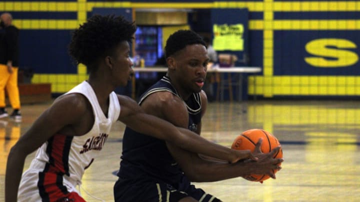 Paxon forward Kyle Jones (0) vies for a loose ball with Weston Sagemont guard Ashton Smith (1) in a River City Basketball Classic boys game on January 21, 2022. [Clayton Freeman/Florida Times-Union]