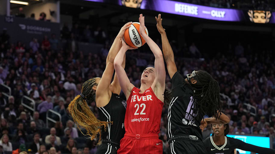 Golden State Valkyries guard Veronica Burton (left) blocks a shot by Indiana Fever guard Caitlin Clark (22) with guard Tiffany Hayes (center right) during the fourth quarter at Chase Center. | Darren Yamashita-Imagn Images
