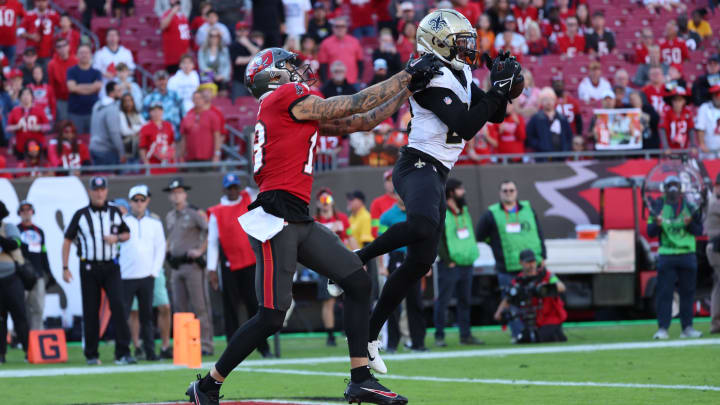 New Orleans Saints cornerback Paulson Adebo (29) intercepts a pass for Tampa Bay Buccaneers wide receiver Mike Evans (13) 